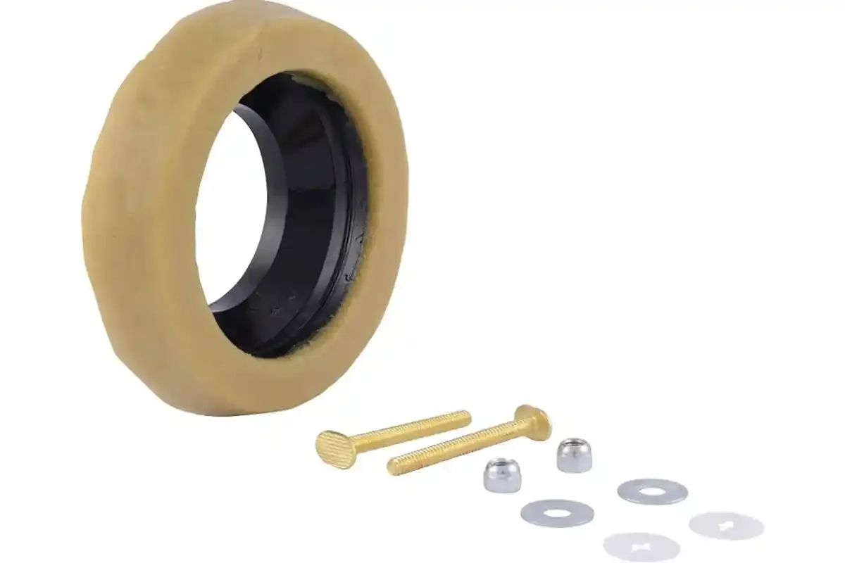 Wax ring, closet bolts and washers laid out for a toilet flange installation